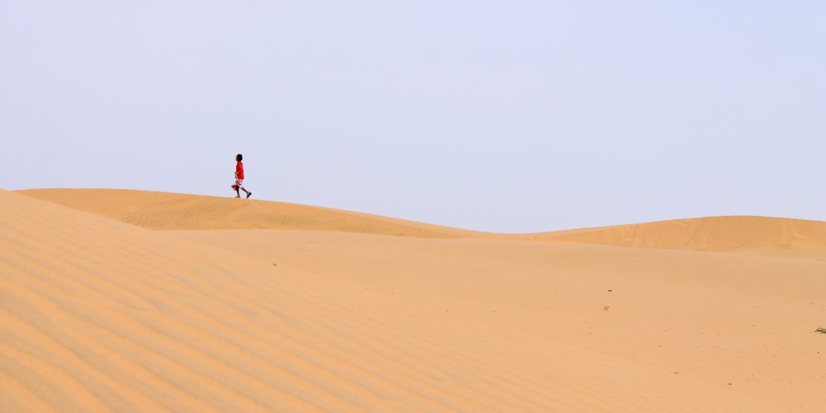 persona che cammina nel deserto.